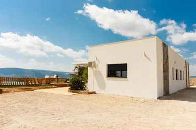 a white house in the desert with a sky at La villa de Naomi in Chella