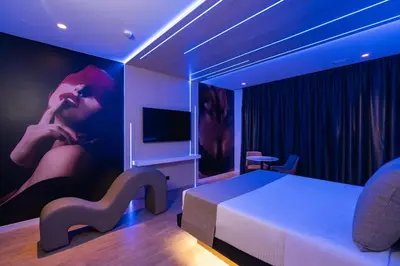 a hotel room with a bed and a tv and a room with at Motel JOC in Valencia