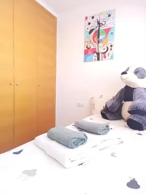 a bedroom with a teddy bear sitting on a bed at Cozy townhouse in Soneja in Soneja