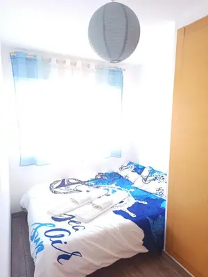 a bedroom with a bed with a blue and white blanket at Cozy townhouse in Soneja in Soneja