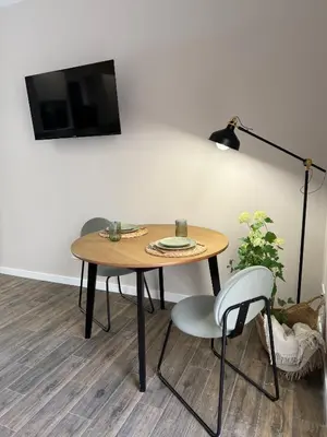 a table with a lamp and a tv on a wall at Urban Soul Studio in Valencia