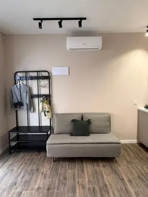 a living room with a couch and a wall at Urban Soul Studio in Valencia