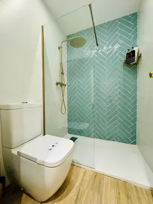 a bathroom with a toilet and a glass shower at Cozy & Stylish Loft near City Center in Valencia