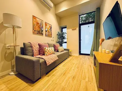 a living room with a couch and a large window at Cozy & Stylish Loft near City Center in Valencia