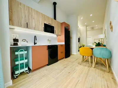 a kitchen with a table and chairs in a room at Stylish Studio near City Center in Valencia