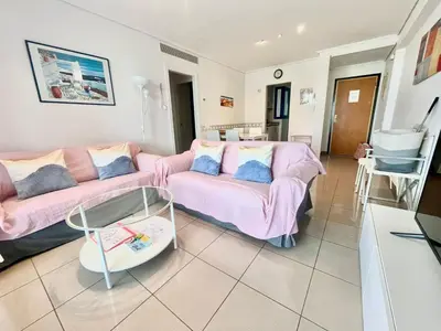 a living room with two pink couches and a table at Playa La Patacona in Valencia