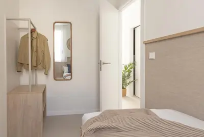a bedroom with a bed and a mirror on the wall at Líbere Valencia Ruzafa in Valencia