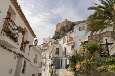 a street in a town with a mountain in the background at Miralrio Chulilla in Chulilla