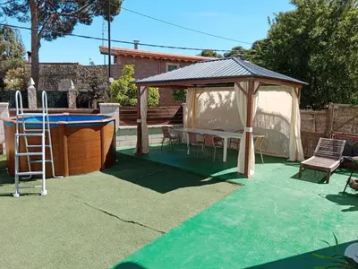 a backyard with a gazebo and a ping pong table at Vacansis Chalet 3 Vedat in Torrent