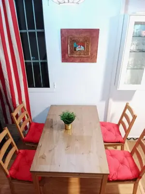 a wooden table with two chairs and a potted plant at Vacansis Chalet 3 Vedat in Torrent