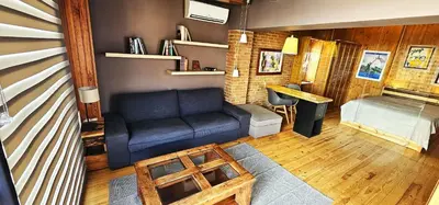a living room with a blue couch and a table at Vacansis Atico Loft El Mercat in Valencia