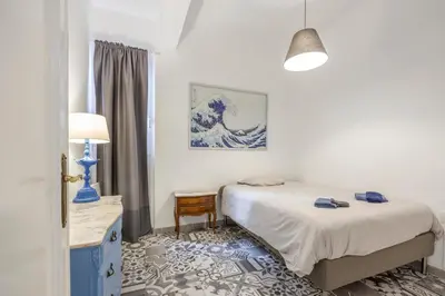 a bedroom with two beds and a table with a lamp at Apartment Ruzafa 4 bedroom in Valencia