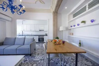 a living room with a blue couch and a wooden table at Apartment Ruzafa 4 bedroom in Valencia