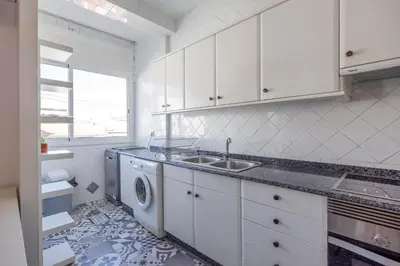 a kitchen with a sink and a washing machine at Apartment Ruzafa 4 bedroom in Valencia