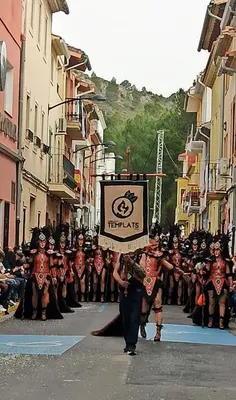 a group of people walking down a street in a parade at Casa Maibeca in Bolbaite