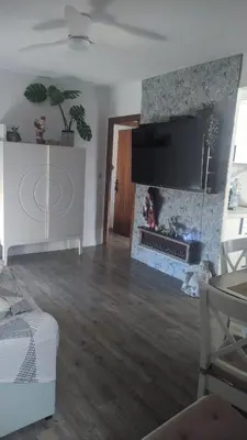 a living room with a fireplace and a tv at arena y mar in Tavernes de Valldigna