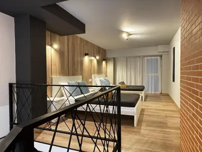 a living room with two beds and a staircase at Cruilles 13 in Valencia