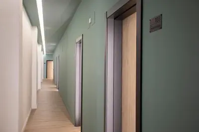 a hallway with white walls and wooden floors at Nomad Haux Mestalla Room 101 in Valencia