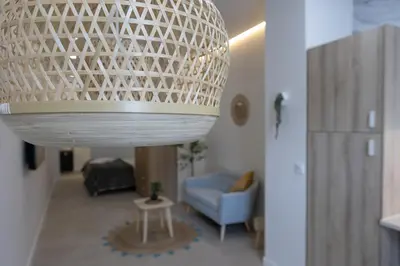 a chandelier in a living room with a blue chair at PPA22 Loft Valencia - Acogedor loft cercano al metro Zona Ayora in Valencia