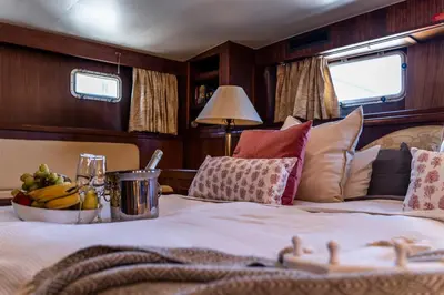 a bedroom with a bed with a bowl of fruit on it at Hotel Yacht Our Alissa in Valencia