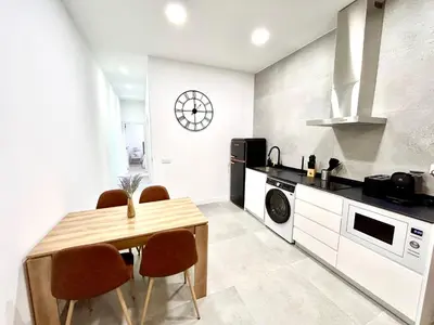 a kitchen with a table and chairs in a room at Valencia Comfort Stay Near Metro, 2 Bed, 1 Bath in Valencia