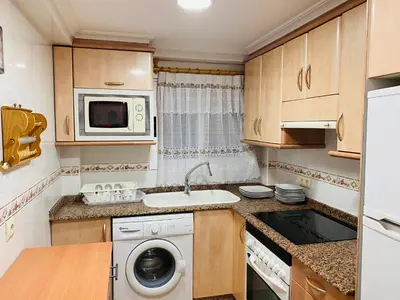 a small kitchen with a sink and a washing machine at Batflats-Palmeres Playa in Sueca