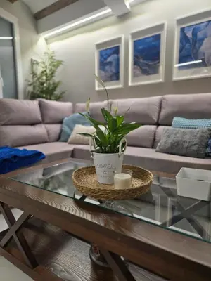 a living room with a couch and a table with a plant at eXperience Apartment Valencia in Valencia