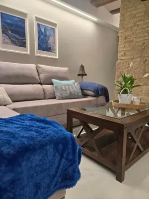 a living room with a couch and a coffee table at eXperience Apartment Valencia in Valencia