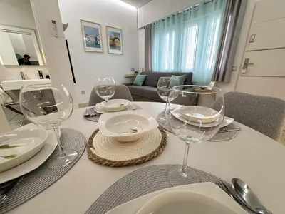 a dining room table with wine glasses on it at Apartamento céntrico cerca de Torres de Serrano y Viveros in Valencia