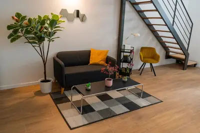 a living room with a couch and a table at PV Loft Valencia - Modernos y cómodos estudios dúplex cerca a Russafa in Valencia