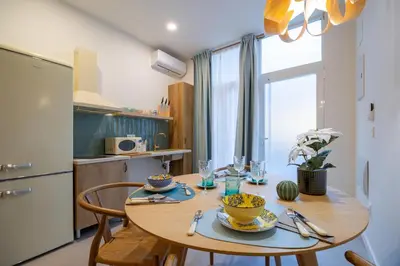 a kitchen with a wooden table with chairs and a dining room at PA20A - Loft Valencia in Valencia