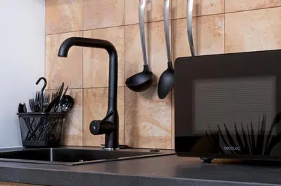 a kitchen counter with a sink and utensils on a wall at ESC - Loft Valencia Cómodos y espaciosos estudios cercanos a estación Joaquín Sorolla in Valencia