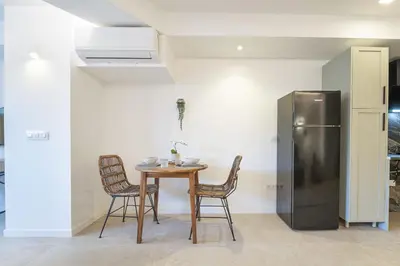 a kitchen with a table and a refrigerator at PALX Loft Valencia - Estudio contemporáneo cerca de las Artes y las Ciencias in Valencia