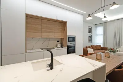 a kitchen and living room with white walls and a counter at GuestReady - Urban elegance in Valencia in Valencia