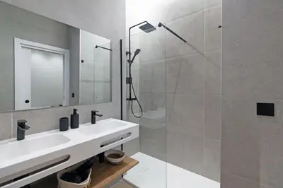 a white bathroom with a sink and a shower at GuestReady - Urban elegance in Valencia in Valencia