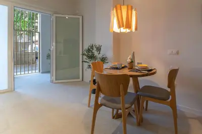 a dining room with a wooden table and chairs at PM - Loft Valencia Espaciosos estudios con terraza cerca a las Artes y las Ciencias in Valencia