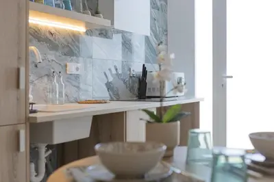 a kitchen with a counter with bowls on a table at UY - Loft Valencia Acogedores y modernos estudios cerca de la estación Joaquín Sorolla in Valencia