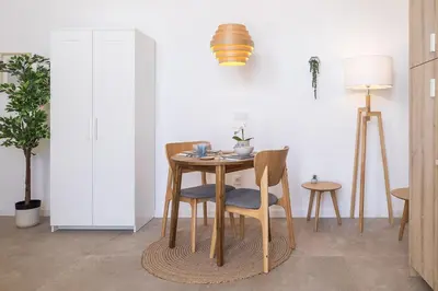 a dining room with a table and two chairs at UY - Loft Valencia Acogedores y modernos estudios cerca de la estación Joaquín Sorolla in Valencia