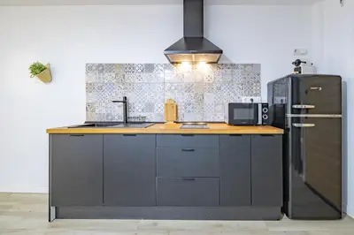 a kitchen with a sink and a refrigerator at LN4 - Loft Valencia Espacioso y acogedor estudio cerca del metro zona Ayora in Valencia