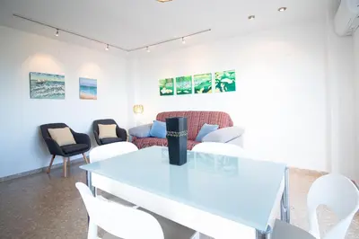 a living room with a table and chairs at Global Vacacional, Apartamento de 3 habitaciones en urbanización cerca del mar in Canet de Berenguer