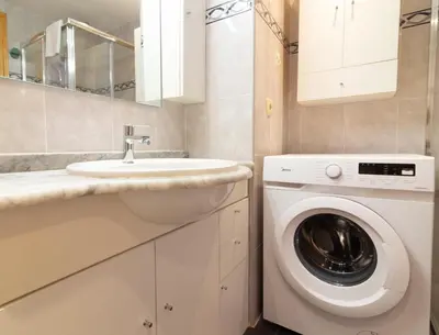 a bathroom with a washing machine and a sink at Global Vacacional, Apartamento de 3 habitaciones en urbanización cerca del mar in Canet de Berenguer