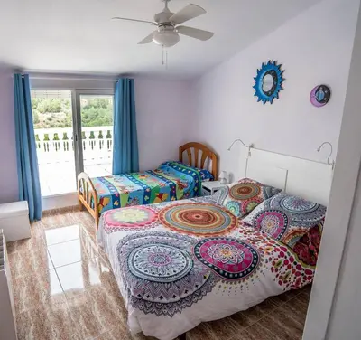 a bedroom with two beds and a ceiling fan at La Casa de la Cascada in Anna