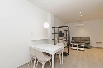 a living room with a table and chairs and a couch at GuestReady - One lovely home in Valencia in Valencia