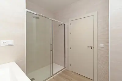 a shower in a bathroom with a glass door at GuestReady - One lovely home in Valencia in Valencia
