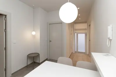 a white dining room with a white table and chairs at GuestReady - One lovely home in Valencia in Valencia