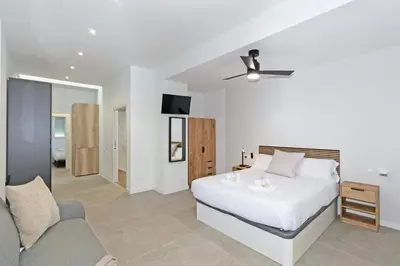 a bedroom with a bed and a ceiling fan at GuestReady - A lovely studio in la Saidia Valencia in Valencia