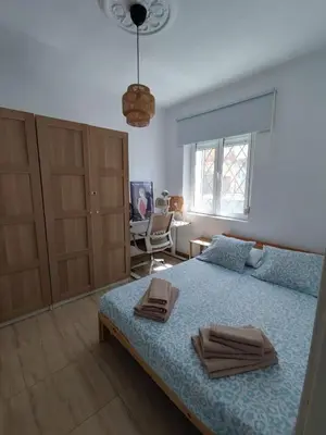 a bedroom with a bed with two towels on it at Apartamento al lado de la playa Malvarrosa in Valencia