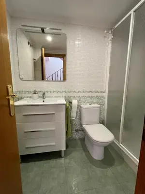 a bathroom with a toilet and a sink and a mirror at Casa Platja Mareny Blau in Mareny Blau