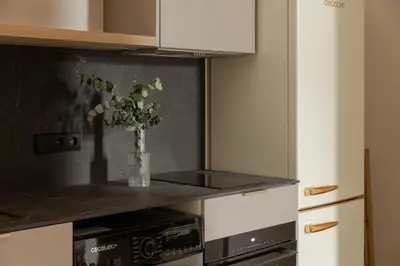 a kitchen with a vase of flowers on a counter at MH Apartments Central Valencia in Valencia