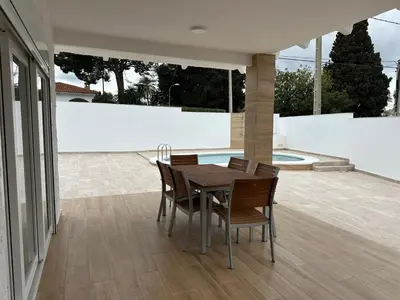 a dining room with a table and chairs on a patio at La Casita in La Eliana